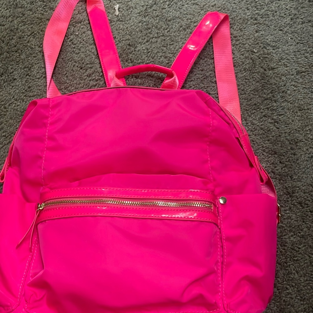 Neon pink backpack with small front zipper pocket